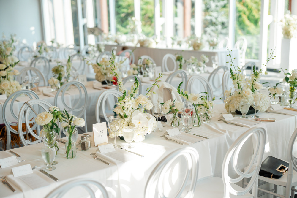 White floral aisle runner laid across a garden lawn
